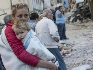 A mother embraces his son in Amatrice, central Italy, where a 6.1 earthquake struck just after 3:30 a.m.,Italy, 24 August 2016. The quake was felt across a broad section of central Italy, including the capital Rome where people in homes in the historic center felt a long swaying followed by aftershocks. ANSA/ MASSIMO PERCOSSI