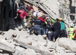 A man injured is carried by rescuers in Amatrice, central Italy, where a 6.1 earthquake struck just after 3:30 a.m., Italy, 24 August 2016. The quake was felt across a broad section of central Italy, including the capital Rome where people in homes in the historic center felt a long swaying followed by aftershocks. ANSA/ MASSIMO PERCOSSI